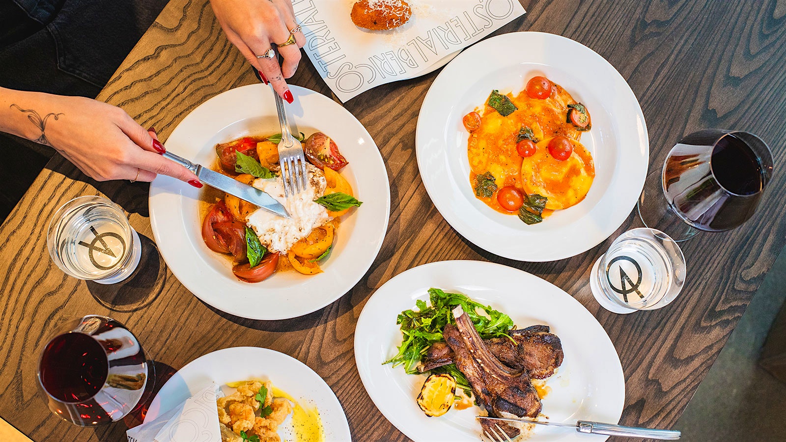 An assortment of dishes and wines from Osteria Alberico in Denver